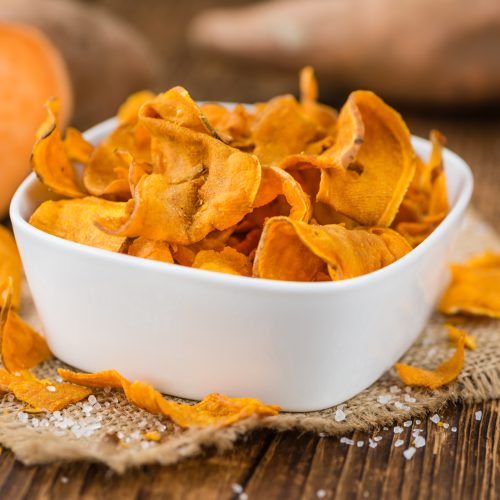 Sweet Potato Chips on a vintage background as detailed close-up shot, selective focus